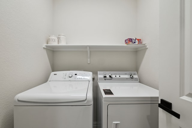 342 Meredith Dr, Fate, TX 75087 - laundry room with washing machine and clothes dryer and a textured wall