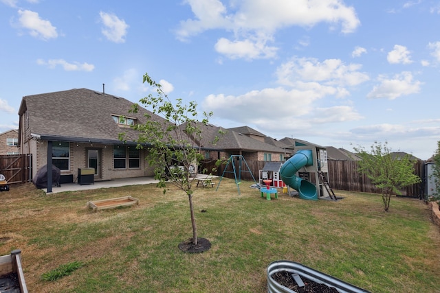 342 Meredith Dr, Fate, TX 75087 - back of house featuring a playground, a patio area, a shingled roof, and brick siding