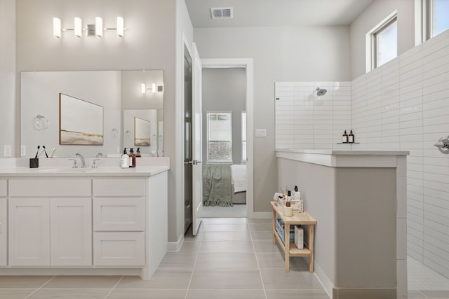 4516 Rustic Ridge Dr, Mckinney, TX 75071 - full bath featuring tile patterned flooring, vanity, a walk in shower, and tile walls