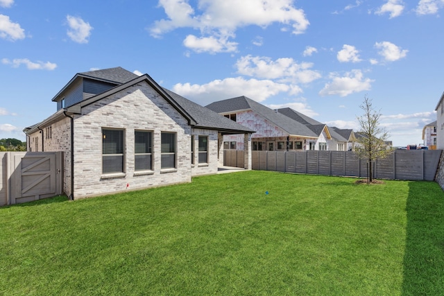 4516 Rustic Ridge Dr, Mckinney, TX 75071 - rear view of house featuring a fenced backyard, a gate, and brick siding