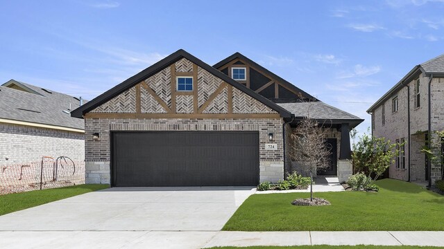 724 Hidden Feather, Lavon, TX 75166 - tudor-style house with stone siding, driveway, a front yard, and an attached garage