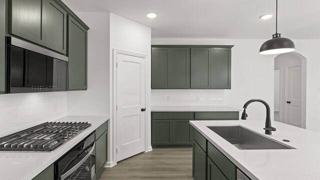724 Hidden Feather, Lavon, TX 75166 - kitchen featuring stainless steel microwave, range, decorative backsplash, recessed lighting, and light wood-style flooring