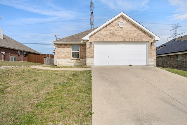 ranch-style house with concrete driveway, an attached garage, a front yard, brick siding, and central AC