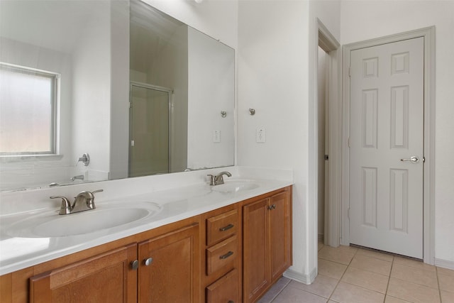 full bathroom featuring tile patterned flooring, double vanity, a sink, and a stall shower