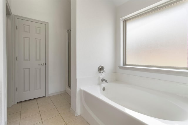 full bathroom with an enclosed shower, a bath, and tile patterned flooring