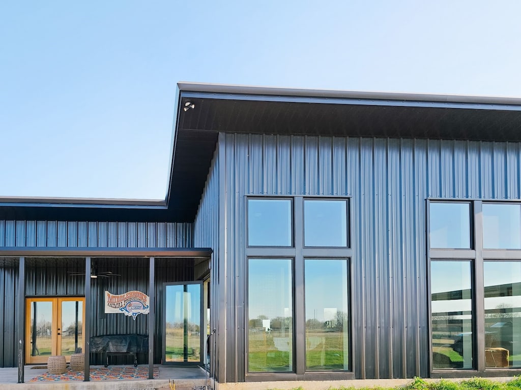back of property featuring french doors and board and batten siding