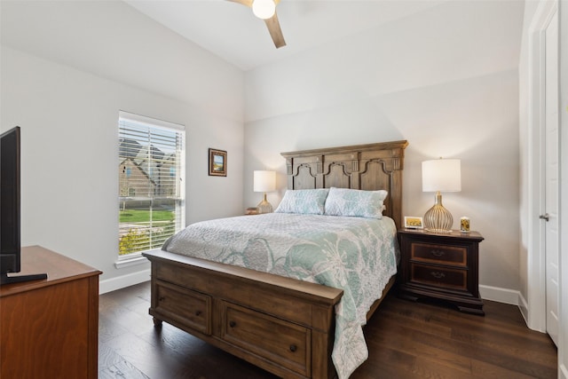 bedroom featuring baseboards, ceiling fan, and dark wood-style flooring