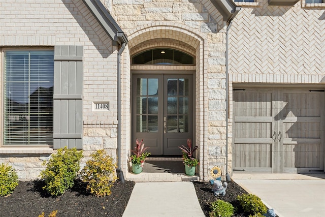 property entrance featuring stone siding and french doors