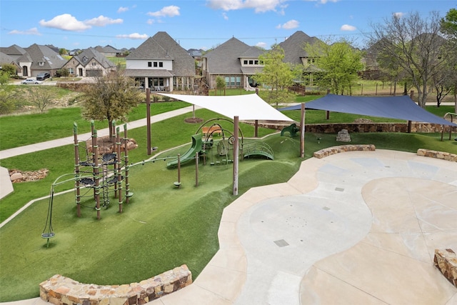 view of property's community with a residential view, playground community, and a lawn