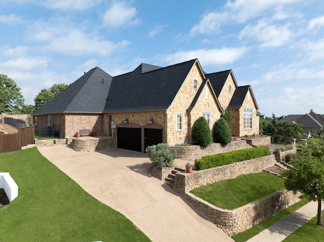 771 Hayden Rd, Lantana, TX 76226 - view of side of home featuring stone siding, concrete driveway, an attached garage, and roof with shingles