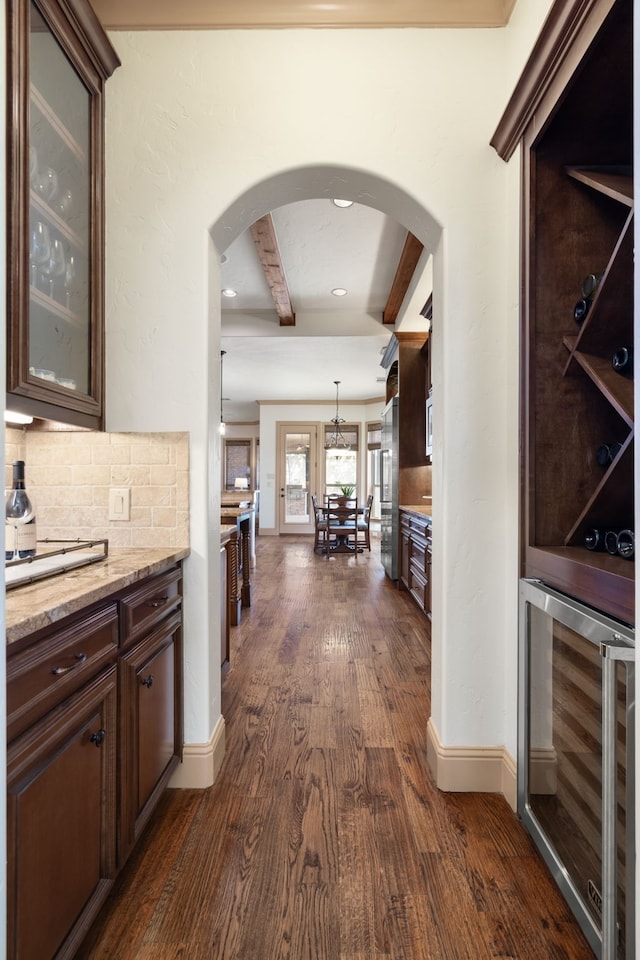 771 Hayden Rd, Lantana, TX 76226 - hall with beverage cooler, dark wood-type flooring, beam ceiling, and arched walkways