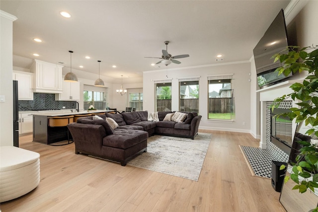 1517 Wild Indigo Dr, Mansfield, TX 76063 - living room with ceiling fan, recessed lighting, light wood-type flooring, crown molding, and a chandelier