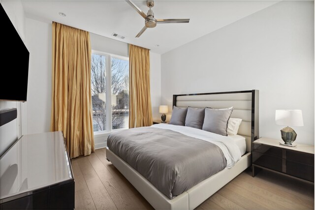 bedroom with visible vents, ceiling fan, and wood finished floors