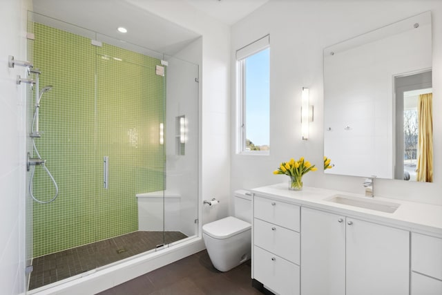 bathroom with tile patterned flooring, toilet, a shower stall, and vanity