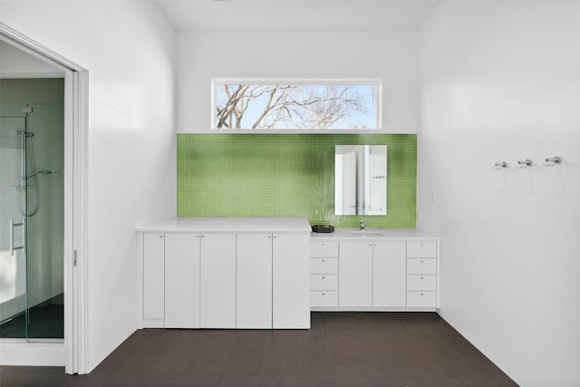 full bath with a shower stall, tile patterned floors, vanity, and backsplash