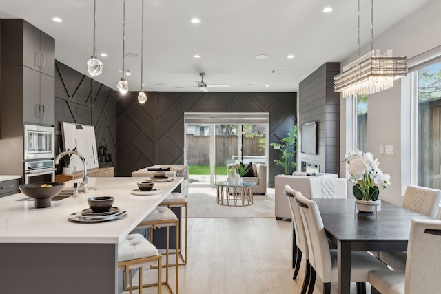 2228 Wycliff Ave, Dallas, TX 75219 - kitchen featuring open floor plan, light countertops, stainless steel appliances, and modern cabinets
