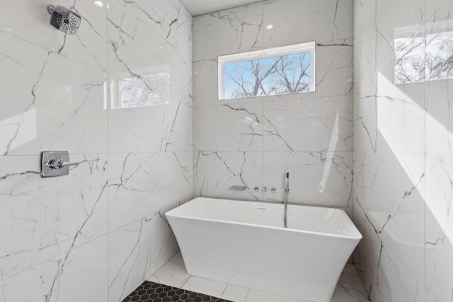 2228 Wycliff Ave, Dallas, TX 75219 - full bath with stone wall, a freestanding bath, and a marble finish shower