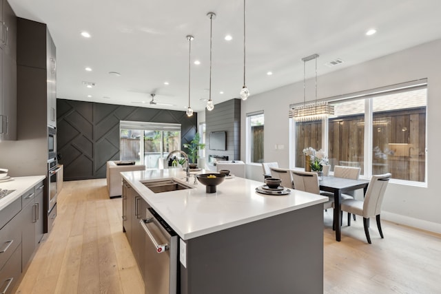 2228 Wycliff Ave, Dallas, TX 75219 - kitchen featuring open floor plan, a sink, modern cabinets, and light wood finished floors