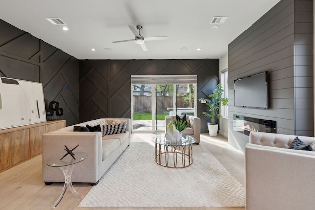 2228 Wycliff Ave, Dallas, TX 75219 - living area with visible vents, a decorative wall, and a ceiling fan