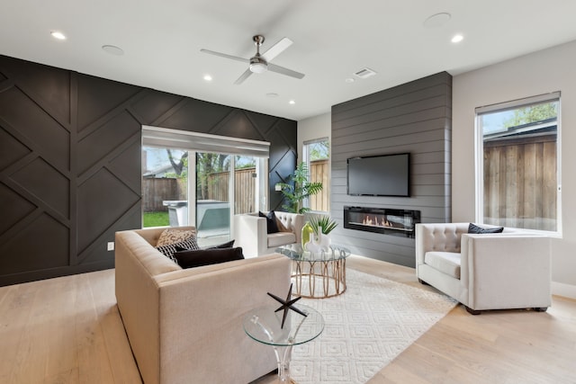 2228 Wycliff Ave, Dallas, TX 75219 - living room with a healthy amount of sunlight, a ceiling fan, and light wood finished floors