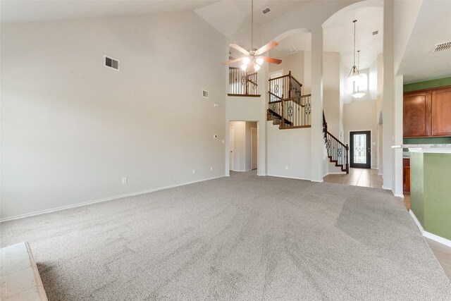 119 Valen Dr, Fate, TX 75189 - unfurnished living room with visible vents, stairs, a ceiling fan, light carpet, and arched walkways