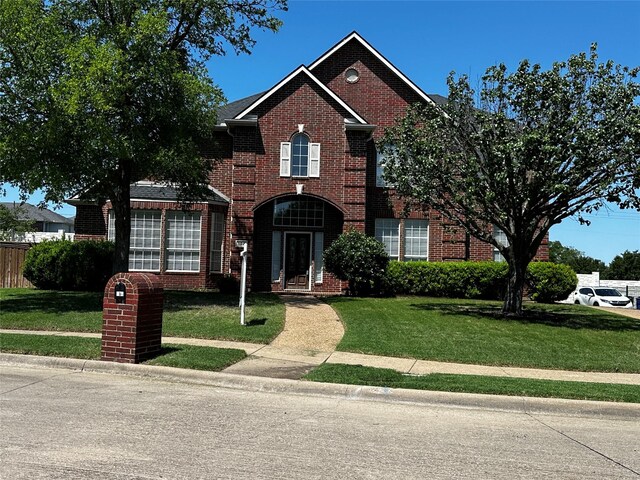 104 Cambridge Ct, Heath, TX 75032 - traditional-style home featuring a front lawn and brick siding