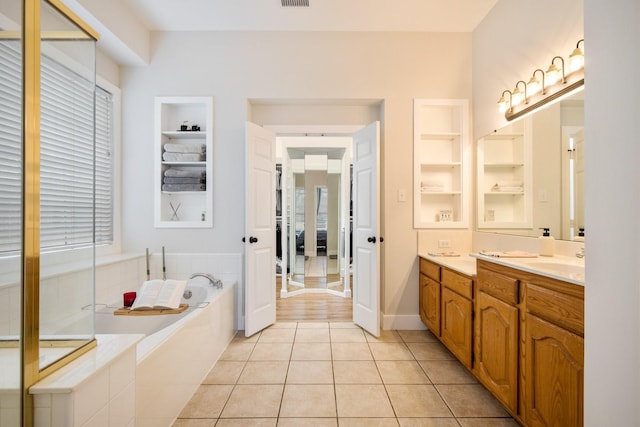 104 Cambridge Ct, Heath, TX 75032 - full bath featuring built in features, vanity, a bath, tile patterned flooring, and baseboards