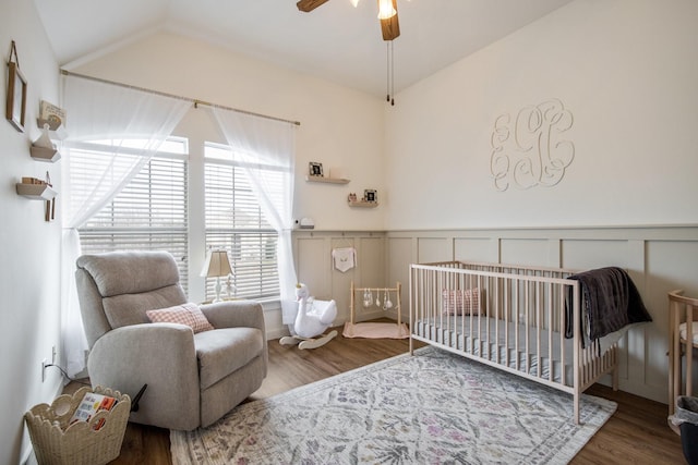 104 Cambridge Ct, Heath, TX 75032 - bedroom with vaulted ceiling, wood finished floors, a crib, a wainscoted wall, and a decorative wall
