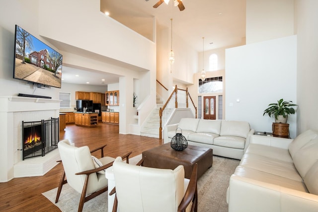 104 Cambridge Ct, Heath, TX 75032 - living room with a towering ceiling, wood finished floors, stairway, recessed lighting, and a ceiling fan