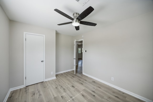 unfurnished bedroom with baseboards, visible vents, ceiling fan, and light wood-type flooring