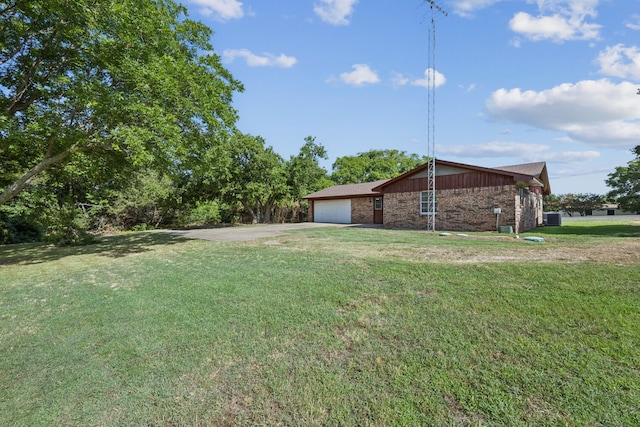 view of yard with driveway and an attached garage