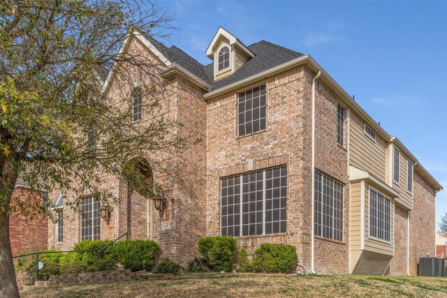 1417 Shadow Brook Trl, Garland, TX 75043 - view of property exterior featuring cooling unit and brick siding