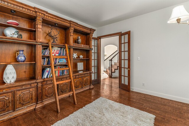 1417 Shadow Brook Trl, Garland, TX 75043 - living area with baseboards, arched walkways, dark wood-type flooring, and french doors
