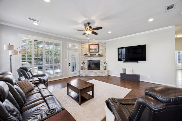 2937 Lago Vista Ln, Rockwall, TX 75032 - living area with a ceiling fan, recessed lighting, dark wood finished floors, ornamental molding, and a stone fireplace