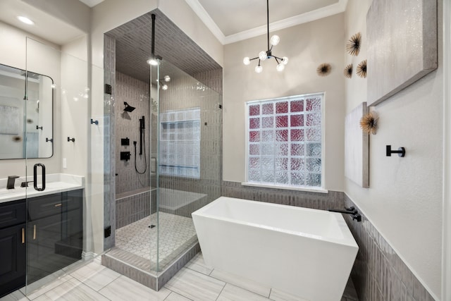 2937 Lago Vista Ln, Rockwall, TX 75032 - full bathroom with a freestanding tub, a stall shower, vanity, tile walls, and crown molding
