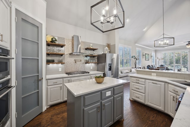 2937 Lago Vista Ln, Rockwall, TX 75032 - kitchen featuring a chandelier, wall chimney exhaust hood, stainless steel appliances, gray cabinets, and decorative backsplash