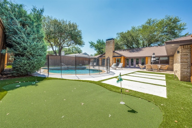 4055 Fawnhollow Dr, Dallas, TX 75244 - view of swimming pool featuring an area to practice putting and a patio