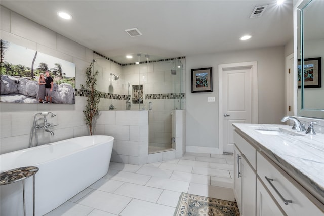 4055 Fawnhollow Dr, Dallas, TX 75244 - bathroom with a freestanding tub, a stall shower, vanity, tile patterned flooring, and recessed lighting