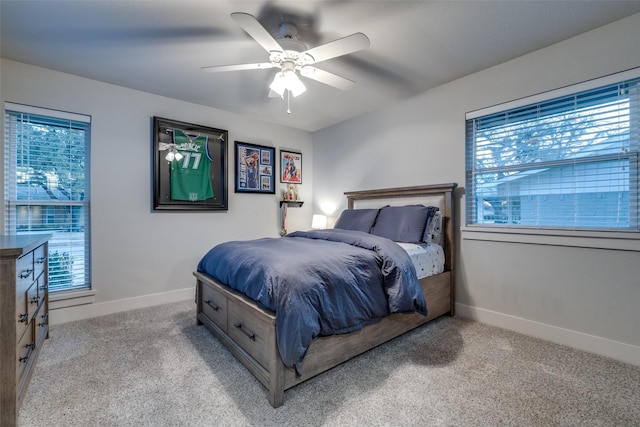 4055 Fawnhollow Dr, Dallas, TX 75244 - carpeted bedroom with multiple windows, baseboards, and ceiling fan