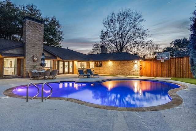 4055 Fawnhollow Dr, Dallas, TX 75244 - pool at dusk featuring french doors and a patio