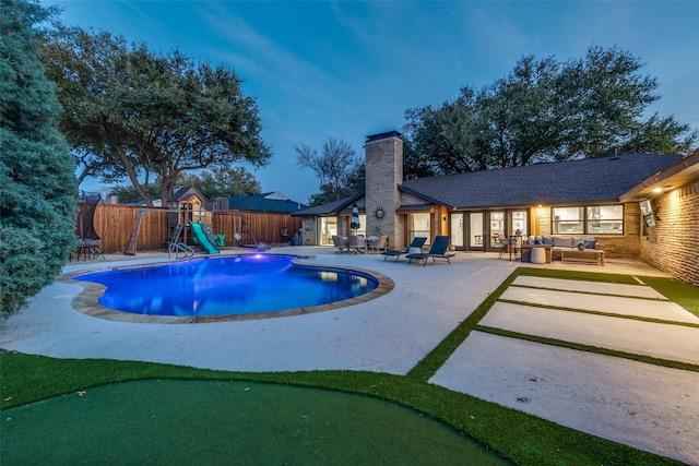 4055 Fawnhollow Dr, Dallas, TX 75244 - view of pool featuring an outdoor living space, a water slide, an area to practice putting, a patio, and a fenced backyard