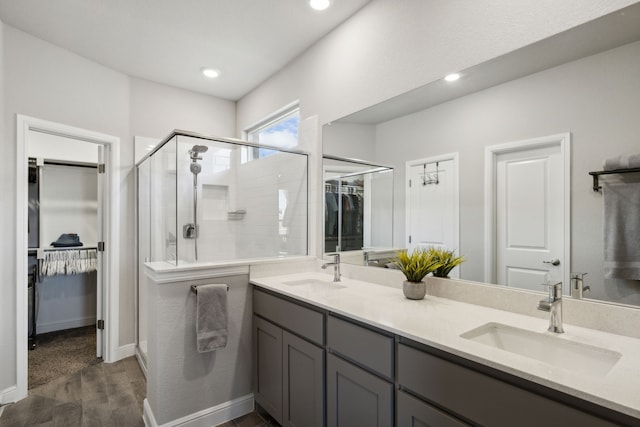 14520 Caelum Dr, Haslet, TX 76052 - full bathroom featuring a walk in closet, double vanity, wood finished floors, a shower stall, and recessed lighting