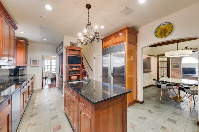 6722 Lakewood Blvd, Dallas, TX 75214 - kitchen with stainless steel built in refrigerator, a chandelier, a sink, a kitchen island with sink, and brown cabinetry