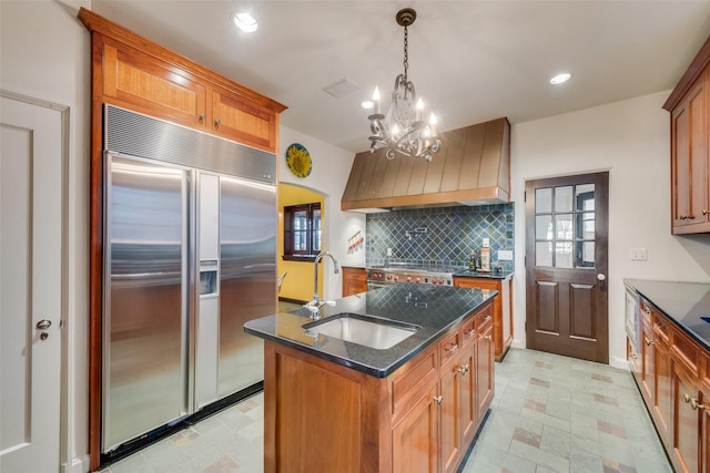6722 Lakewood Blvd, Dallas, TX 75214 - kitchen with stainless steel built in fridge, cooktop, premium range hood, decorative backsplash, and a sink