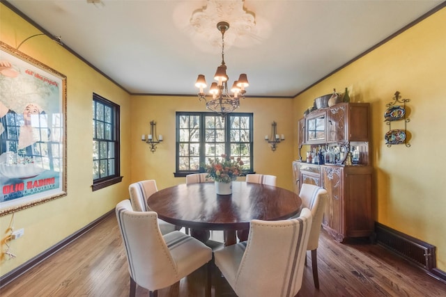 6722 Lakewood Blvd, Dallas, TX 75214 - dining space with dark wood finished floors, visible vents, ornamental molding, and a chandelier