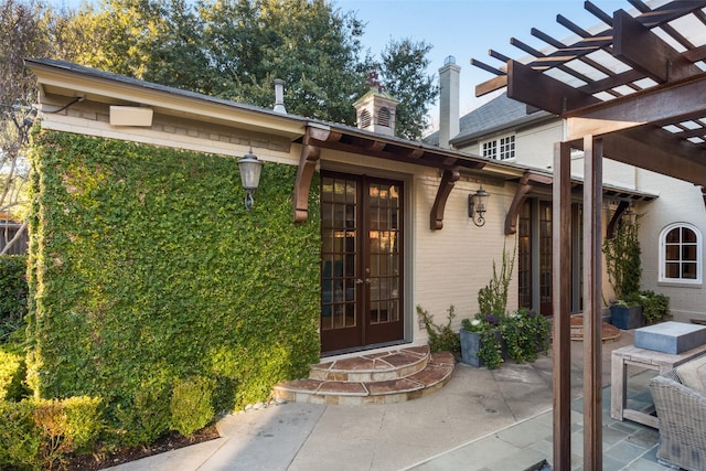 6722 Lakewood Blvd, Dallas, TX 75214 - doorway to property with a pergola, a chimney, a patio area, and french doors