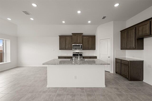 919 Madeline Ln, Cleburne, TX 76033 - kitchen with dishwasher, arched walkways, light tile patterned floors, ceiling fan, and a sink