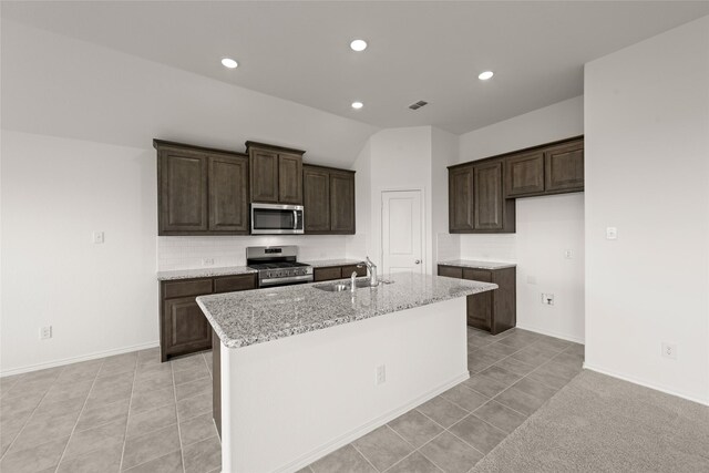 919 Madeline Ln, Cleburne, TX 76033 - kitchen featuring stainless steel appliances, a sink, arched walkways, decorative backsplash, and light stone countertops