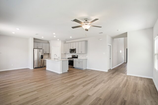 3910 Walmer Way, Princeton, TX 75071 - kitchen featuring stainless steel appliances, open floor plan, a sink, a ceiling fan, and recessed lighting