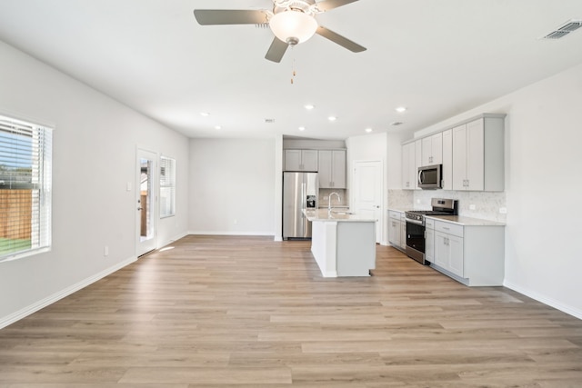 3910 Walmer Way, Princeton, TX 75071 - kitchen featuring stainless steel appliances, open floor plan, recessed lighting, decorative backsplash, and light countertops